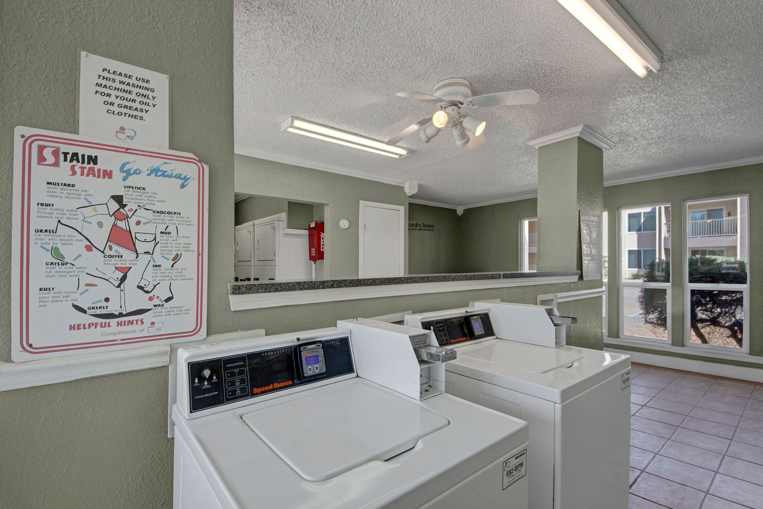 The shared laundry room with multiple washers and dryers for resident use