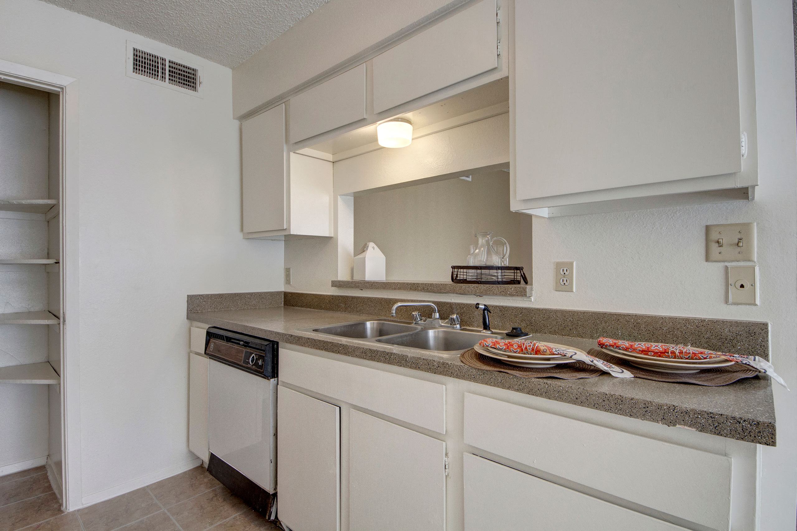 A kitchen with a large pantry and breakfast bar