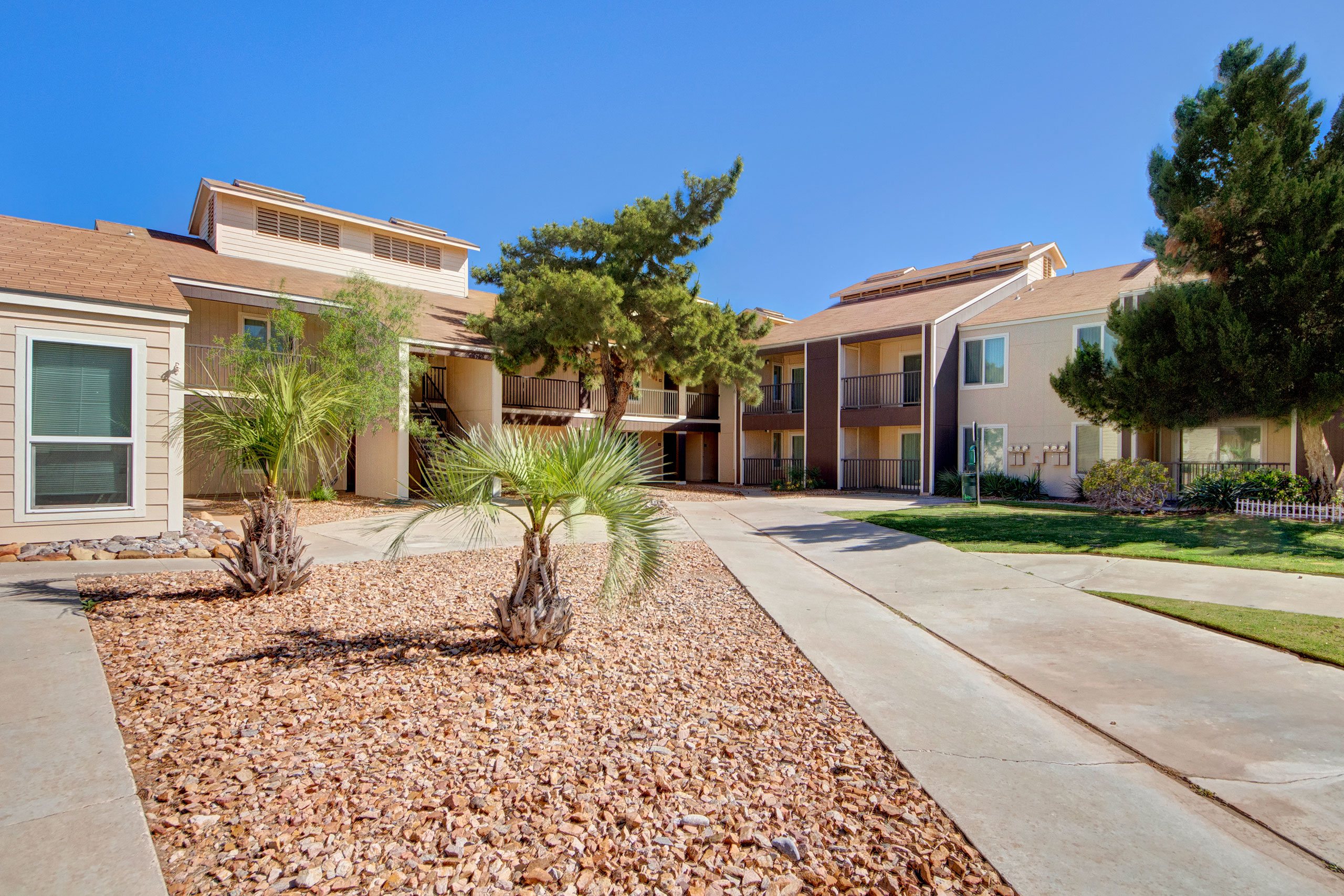 The exterior of the buildings with a path leading through the property to individual units