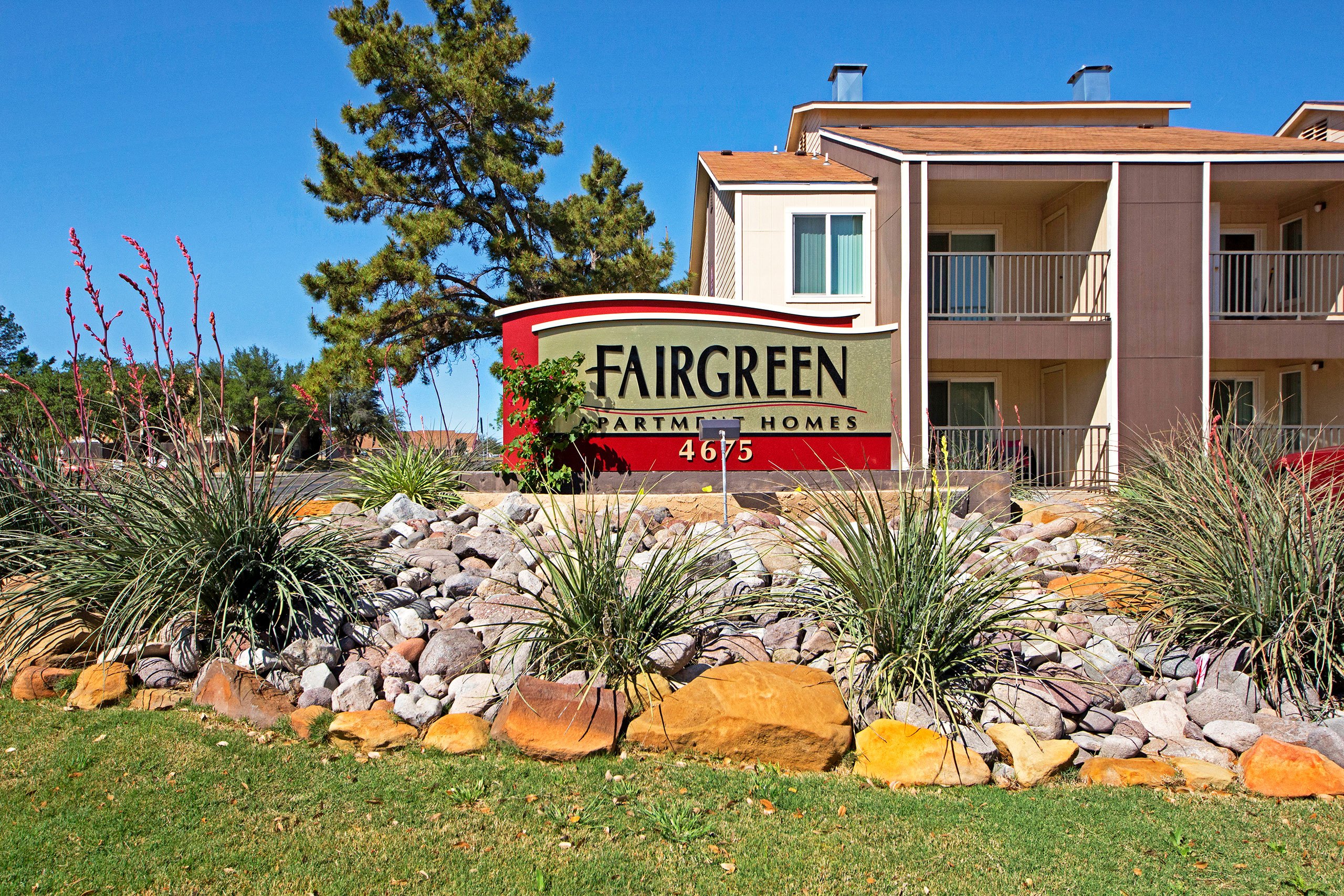 The entrance to the property with a sign that reads Fairgreen Apartment Homes