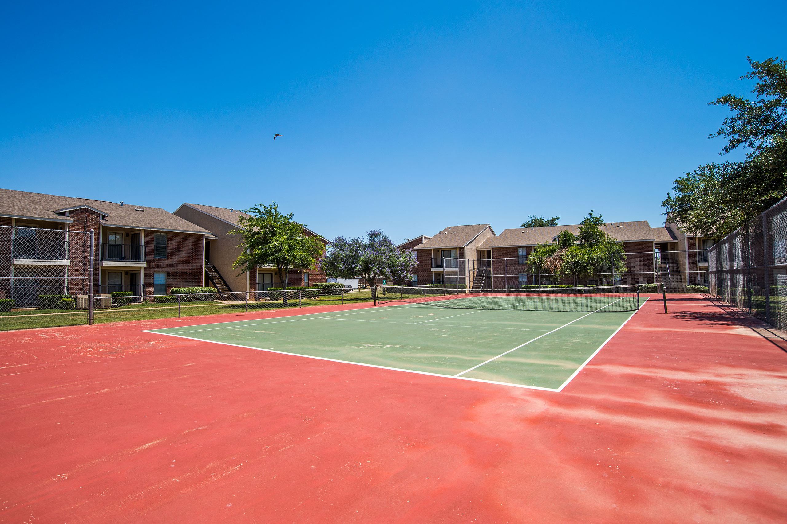 An outdoor tennis court for resident use