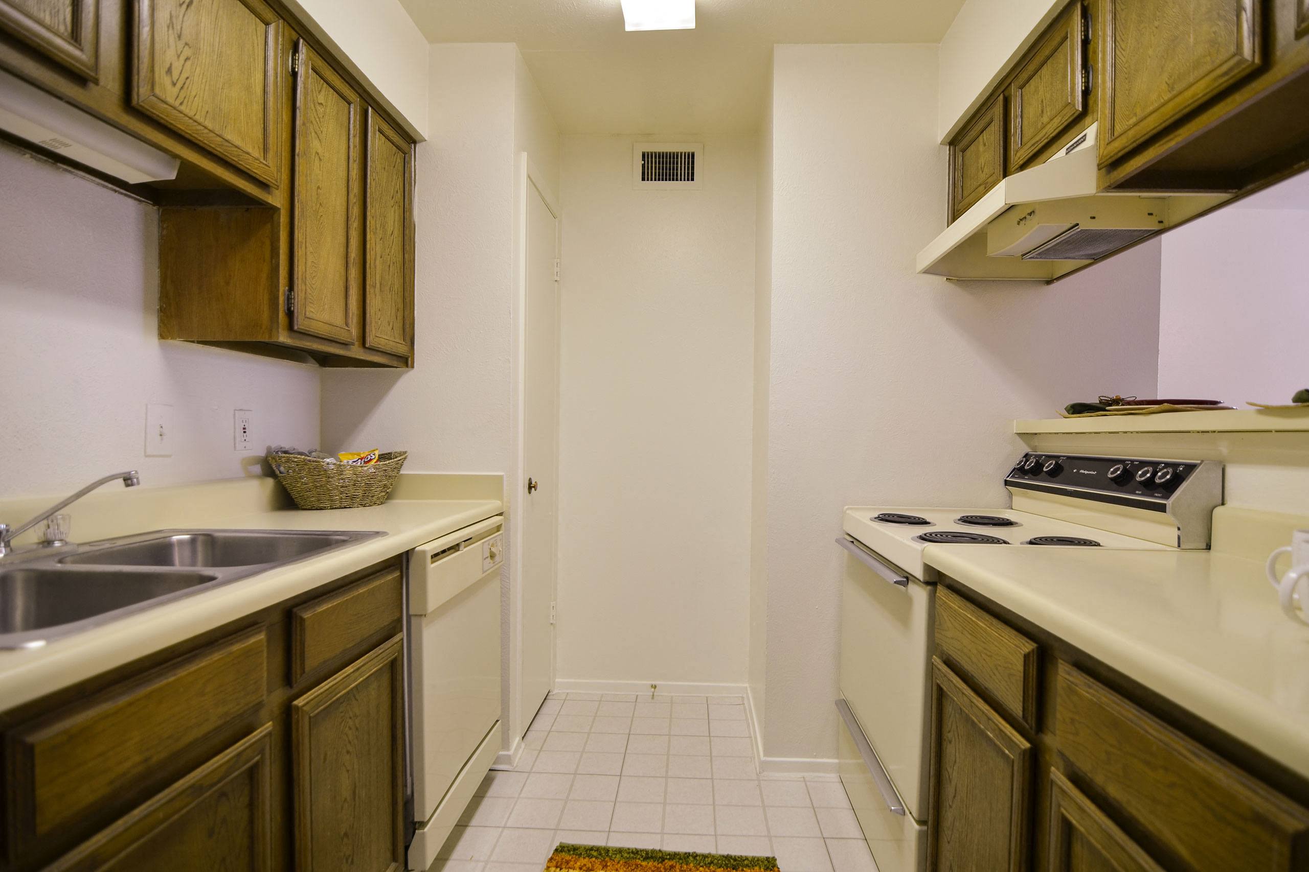 A kitchen with a double sink and a pantry