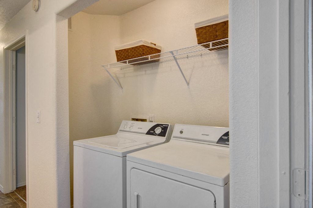 Arezzo Apartments- laundry room with a washer and dryer