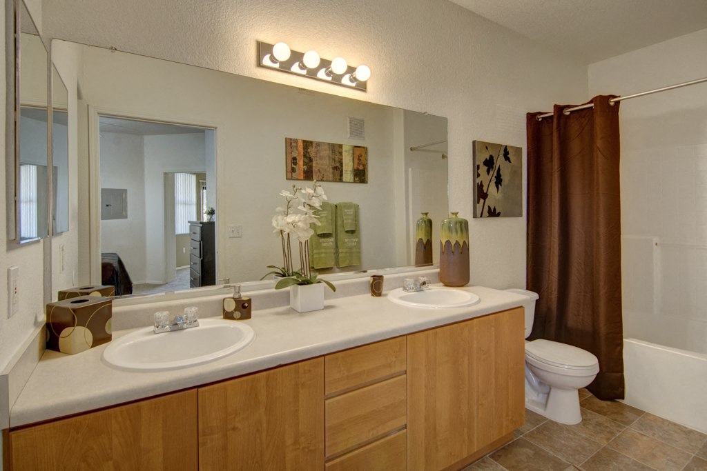 Arezzo Apartments- large bathroom with double sinks and mirrors 
