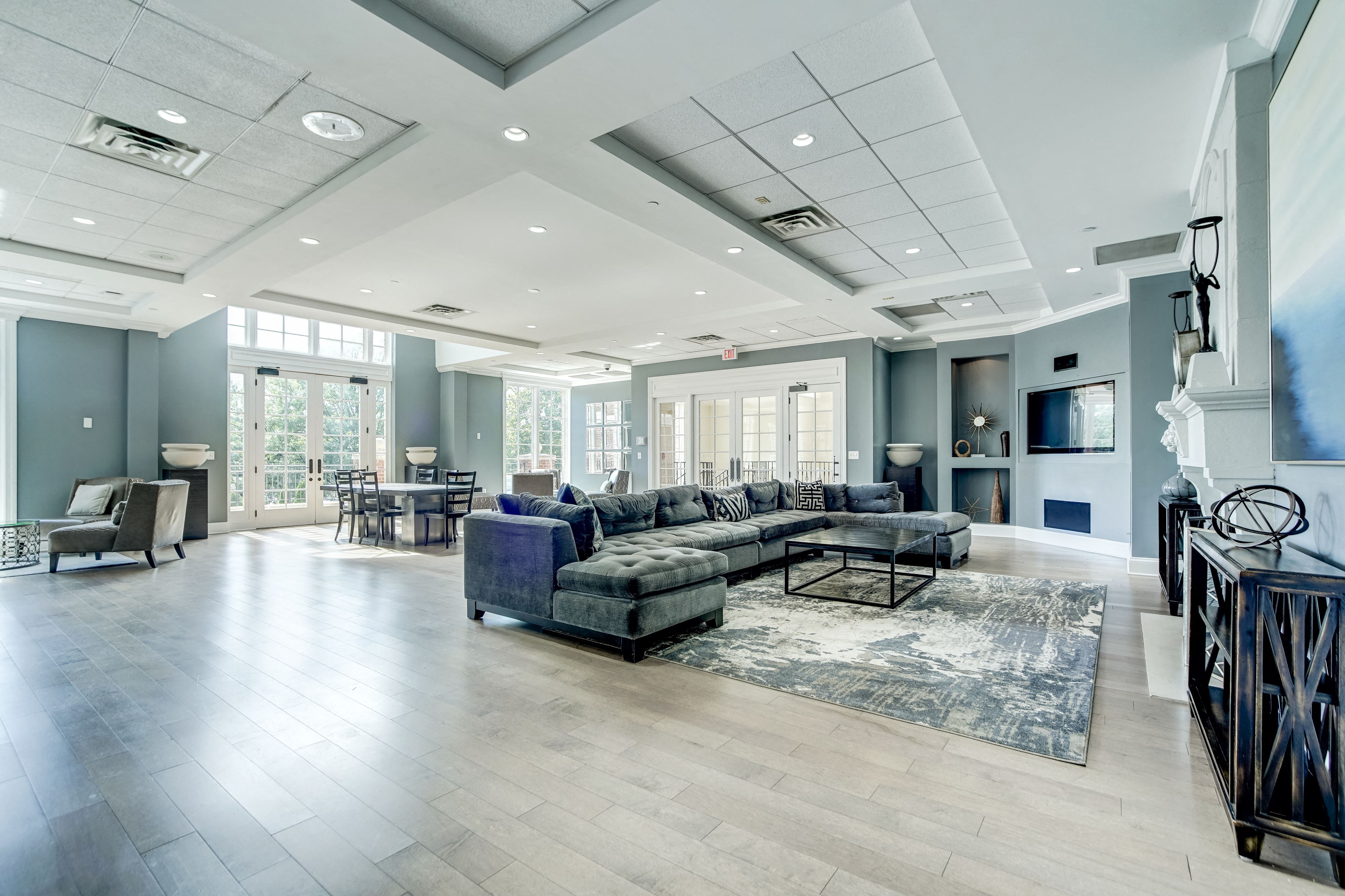 Expansive Resident Clubhouse with Plush Seating Areas, Cozy Fireplace, Balcony Area, and Bar