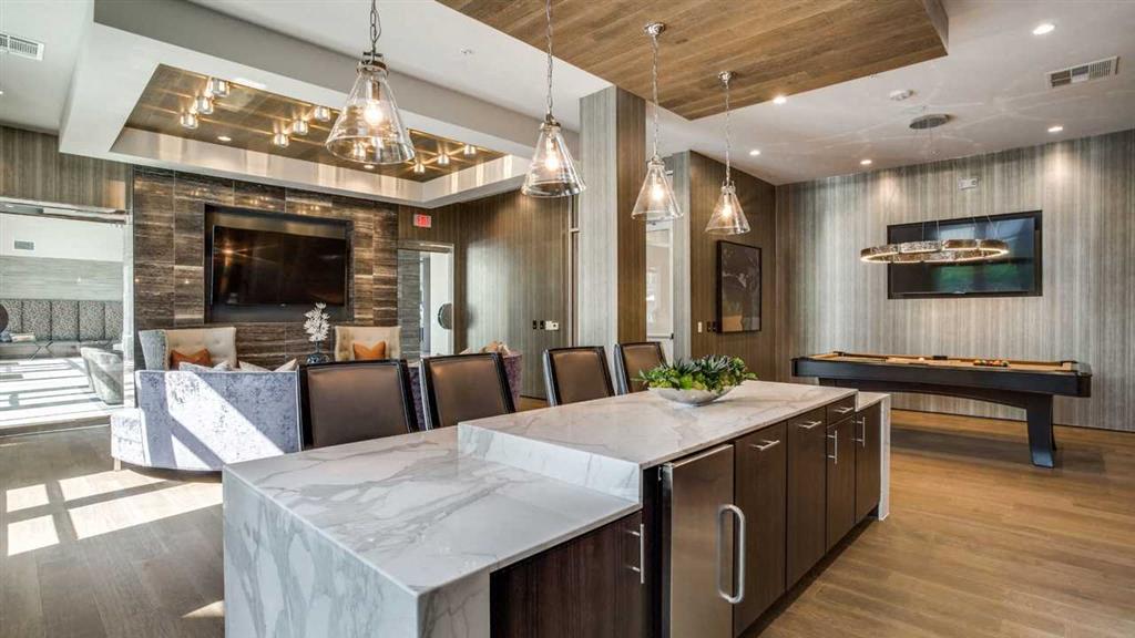 Welcoming community room with pool table and chef's kitchen.