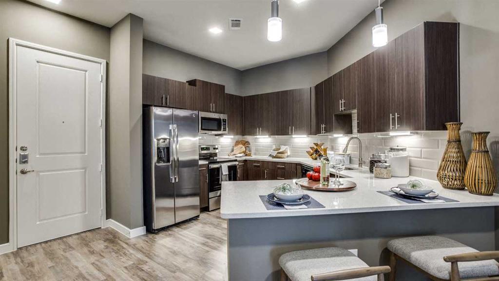 Spacious eat in kitchen with stainless steel appliances.