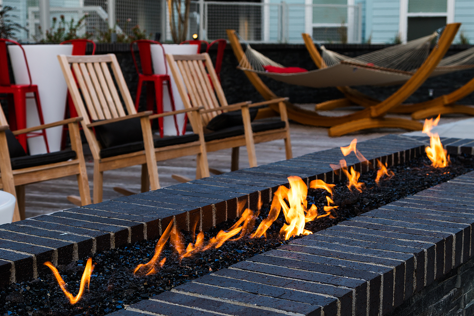 Outdoor living room with fire pit and hammocks
