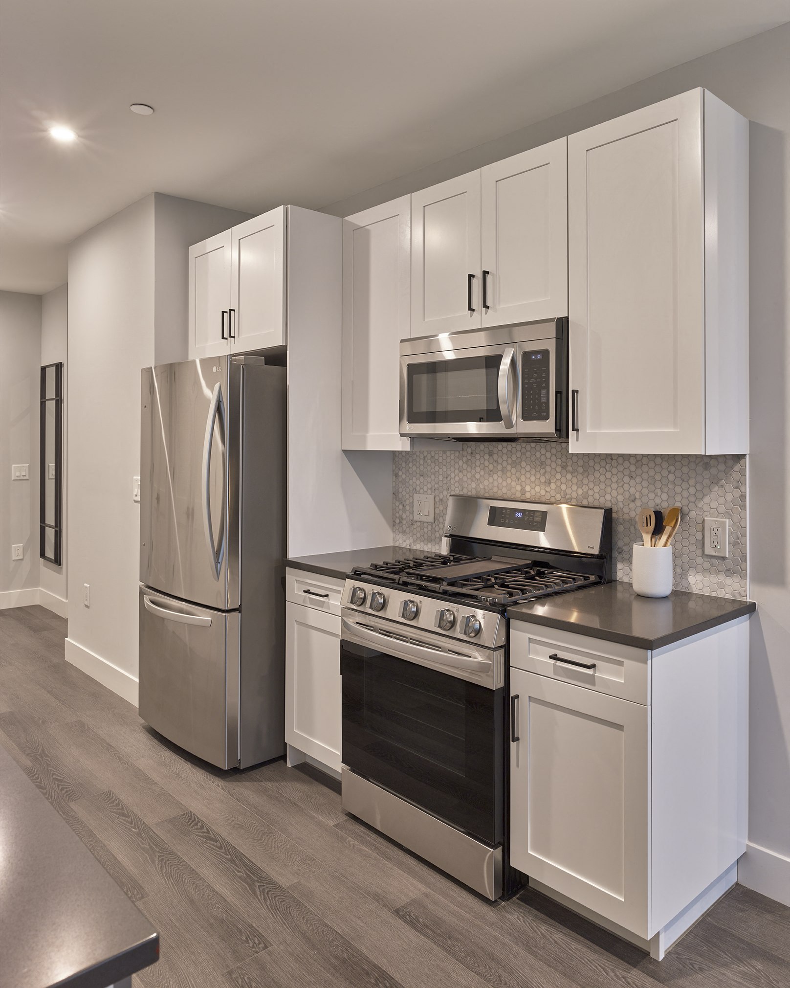 full size stainless-steel appliances, quiet close cabinetry, hardwood floors throughout