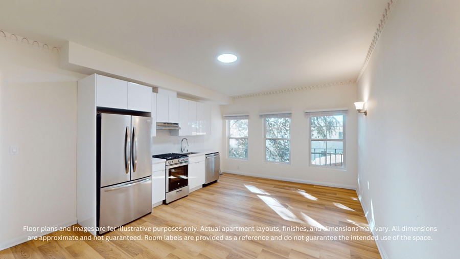 A kitchen with white cabinets and a refrigerator.