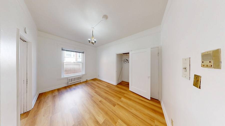 A room with wooden floors and white walls.