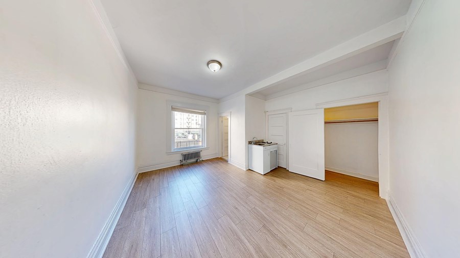 A room with wooden floors and white walls.