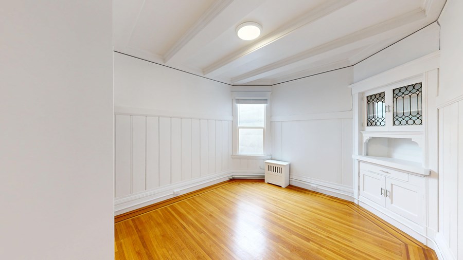 A room with wooden floors and white walls.