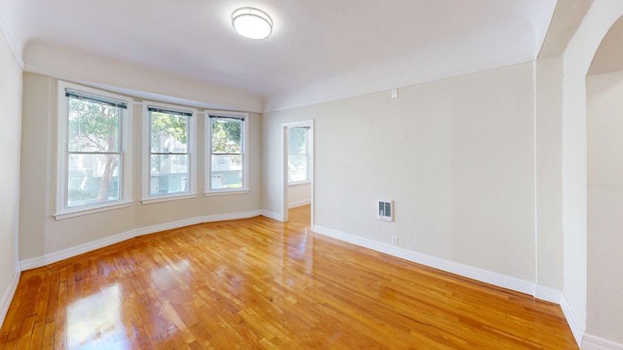 A room with wooden floors and white walls.