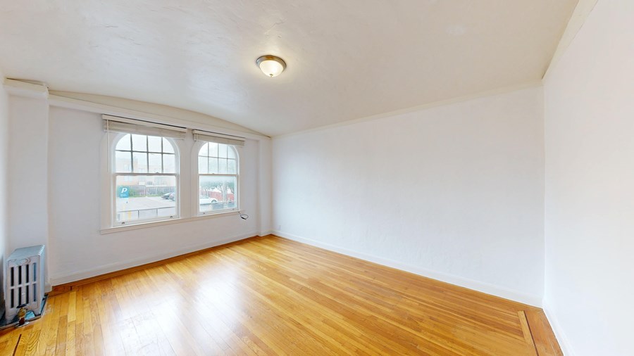 A room with wooden floors and a window.