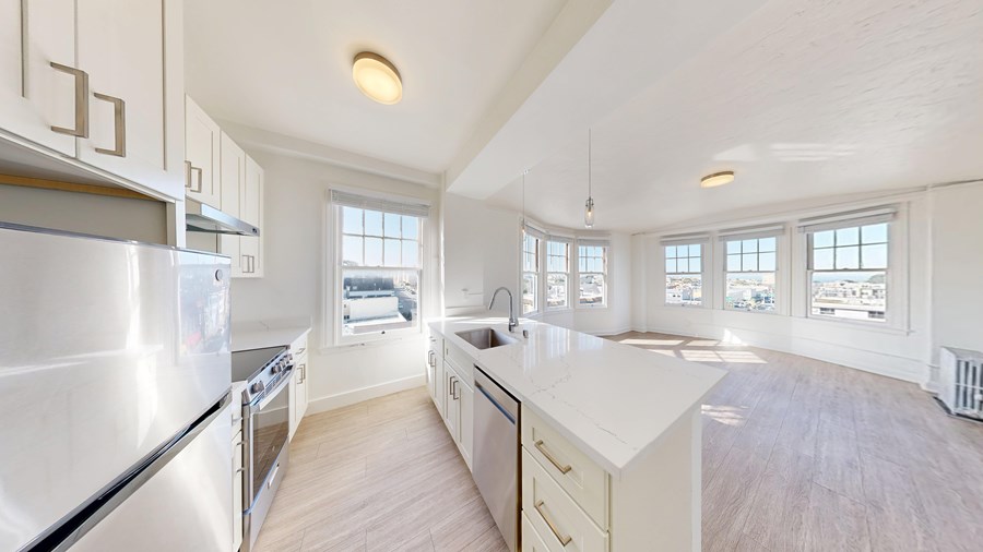 A kitchen with white appliances and cabinets.