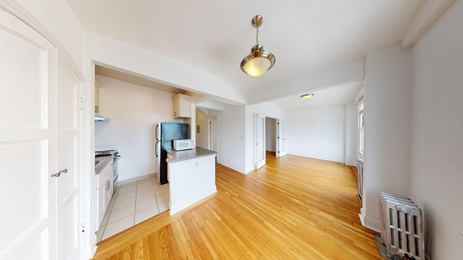 A room with wooden floors and a television.