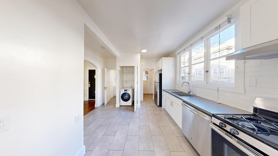 A modern kitchen with a stove top oven and a range hood.