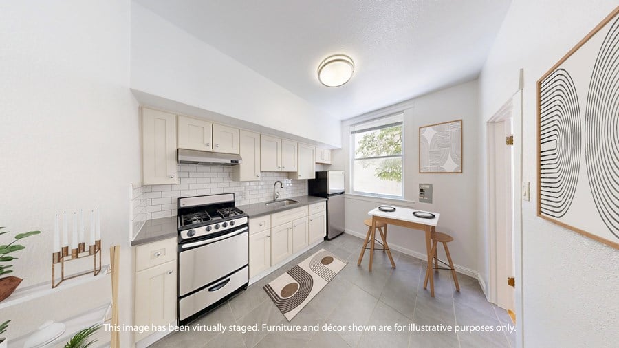 A kitchen with a stove, oven, and sink.