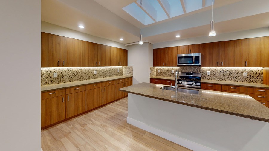 a large kitchen with wooden cabinets and granite counter tops