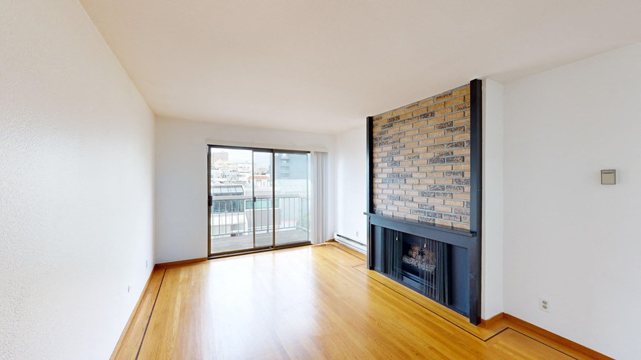 A room with a fireplace and a brick wall.