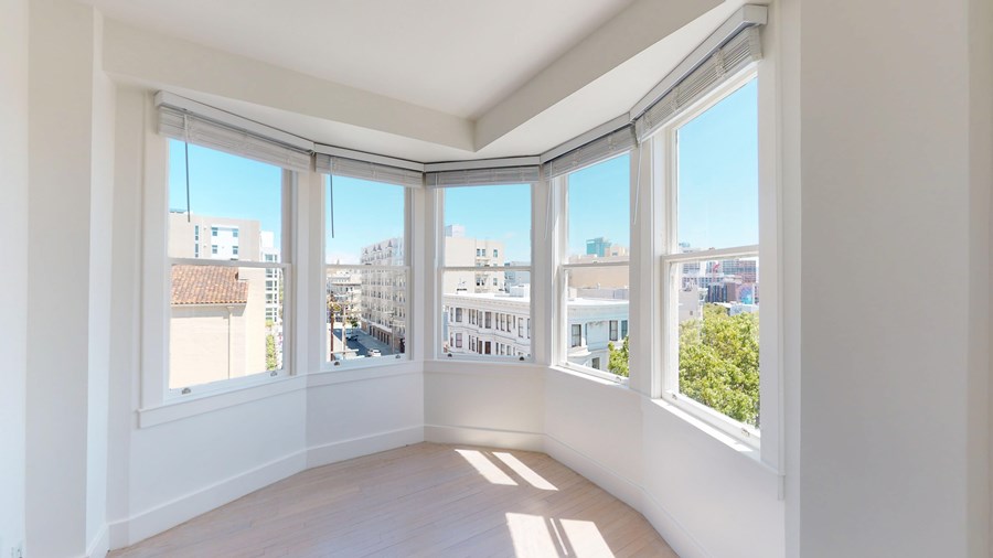 A sunny room with a view of the city.