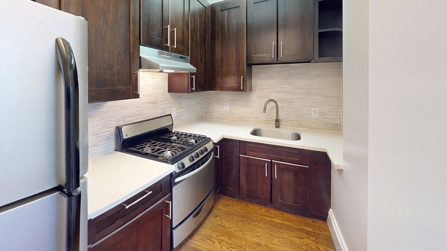 A kitchen with a white fridge and a white stove top oven.