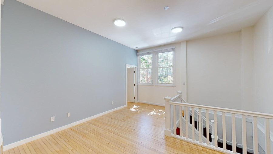 A room with wooden floors and white walls.
