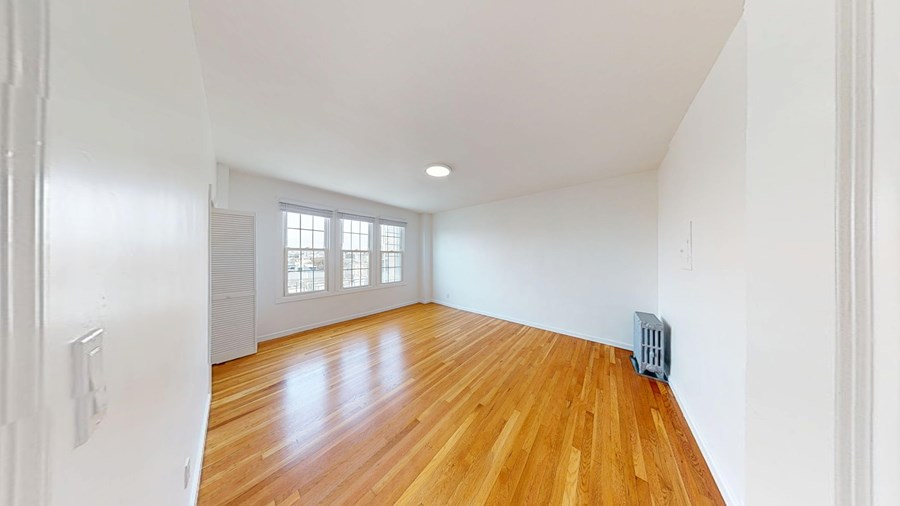 A room with wooden floors and white walls.