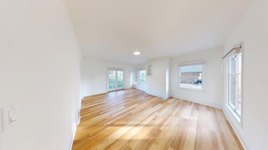A room with wooden floors and white walls.