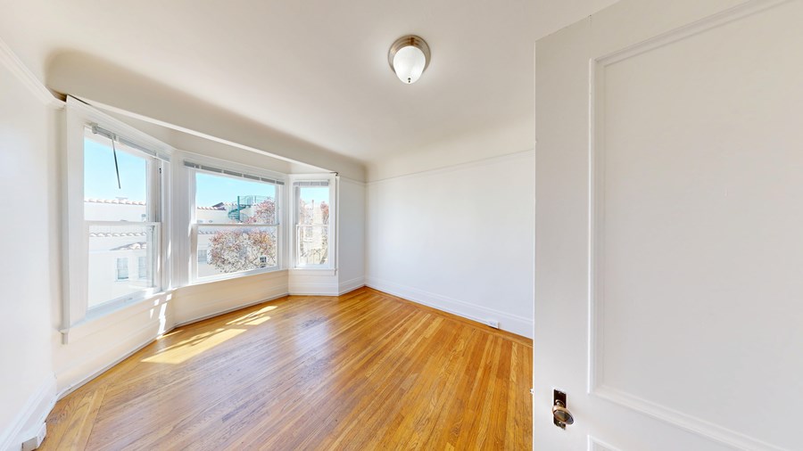 A room with wooden floors and white walls.