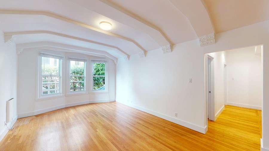 A room with wooden floors and white walls.
