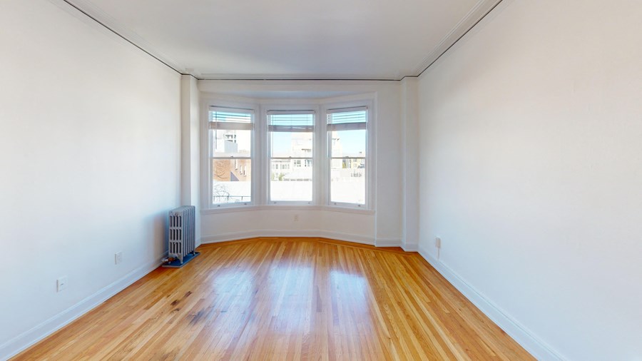 A room with wooden floors and white walls.