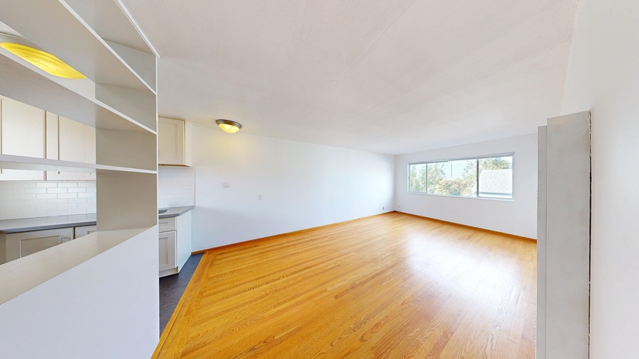 A room with wooden floors and white walls.