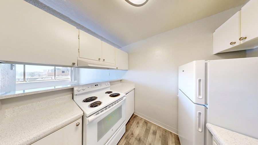 A small kitchen with a stove and refrigerator.