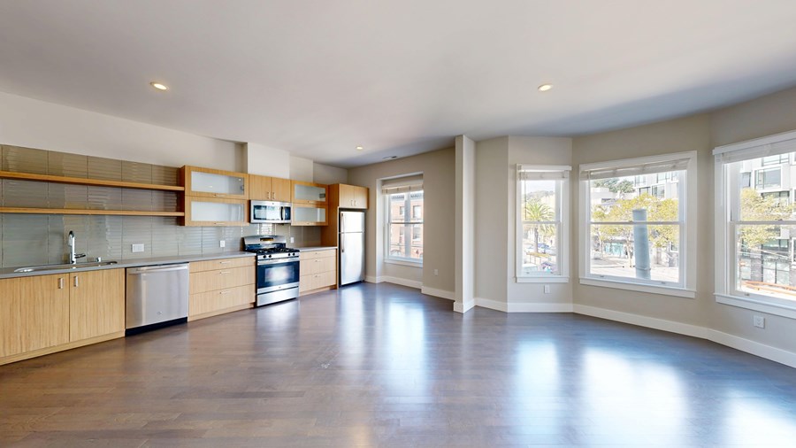 A spacious kitchen with wooden cabinets and a large island.