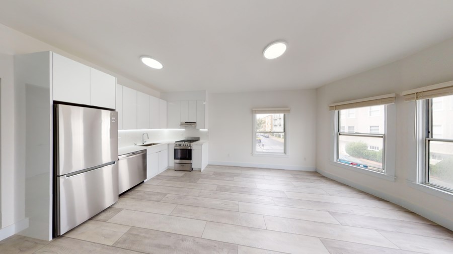 A kitchen with a refrigerator, sink, and oven is shown.