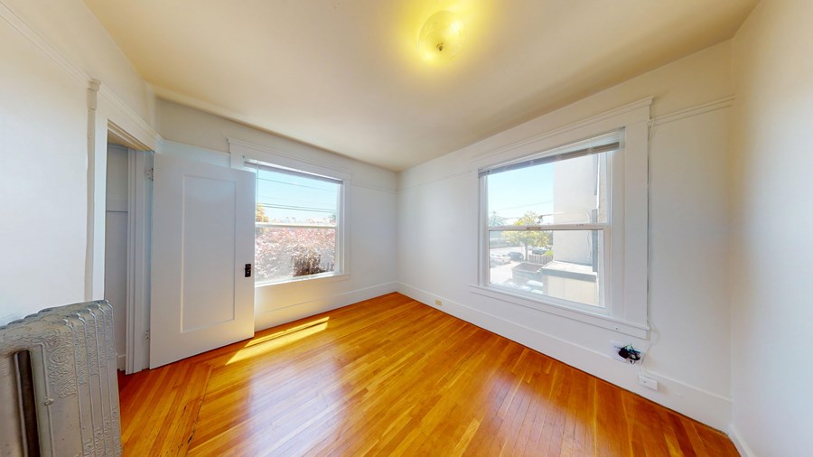 A room with wooden floors and white walls.