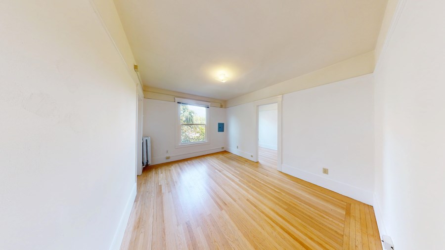 A room with wooden floors and white walls.