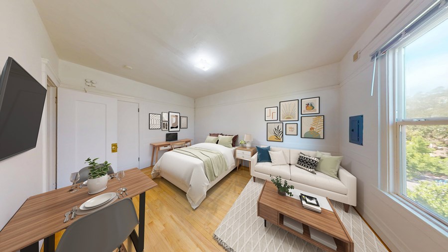 A well-lit, modern bedroom with a large bed and a couch.