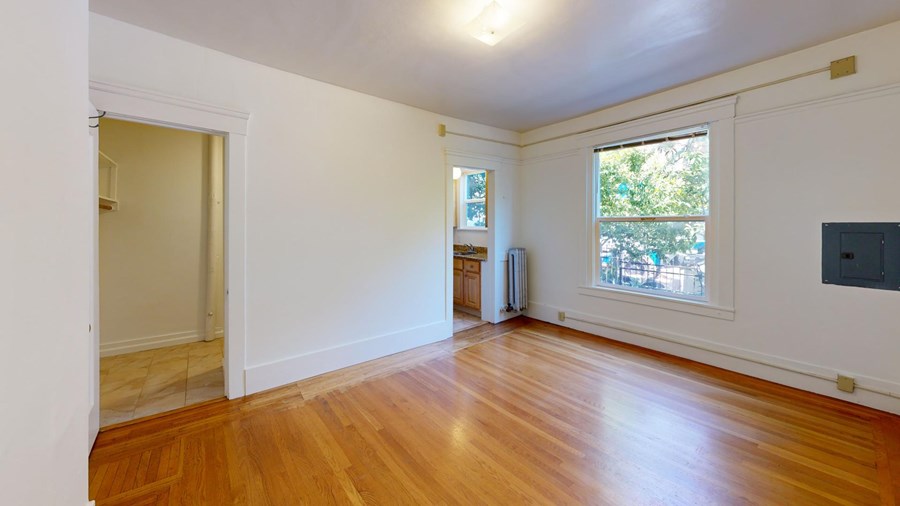 A room with wooden floors and a window.