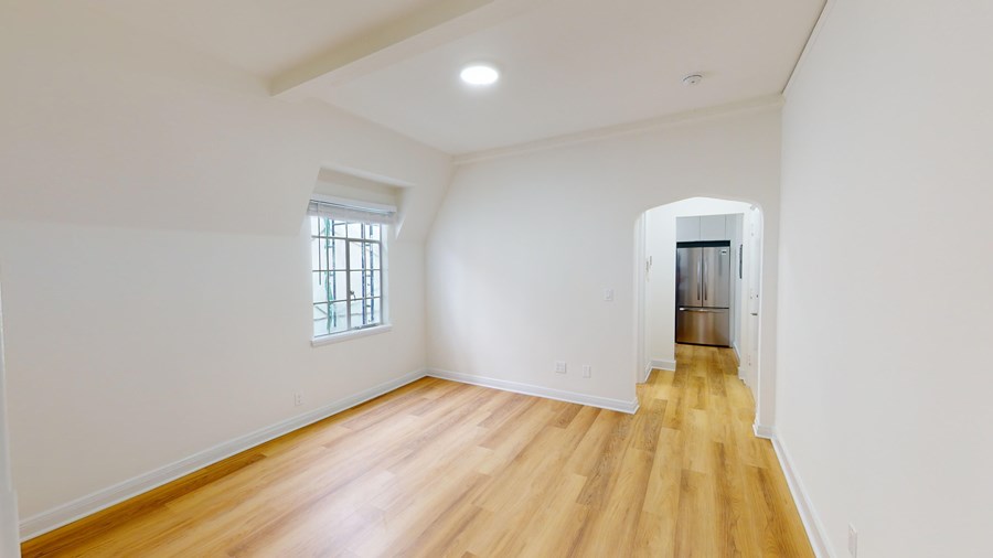 A room with wooden floors and a window.