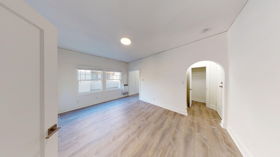 A room with a window and a door.