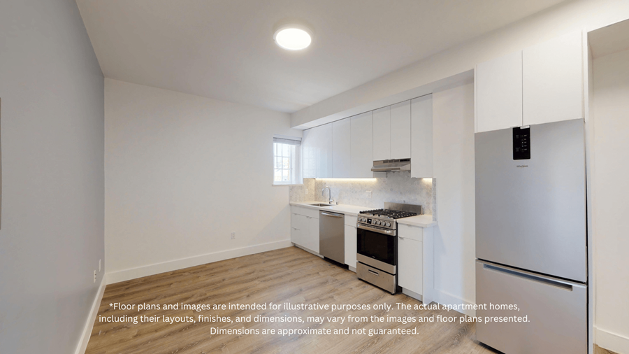 A kitchen with white cabinets and appliances, a window above the sink, and a refrigerator on the right.