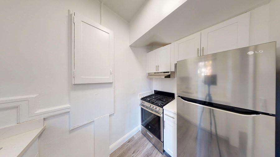 A kitchen with a stove and a refrigerator.