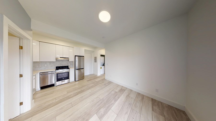A kitchen with a stainless steel oven and microwave.