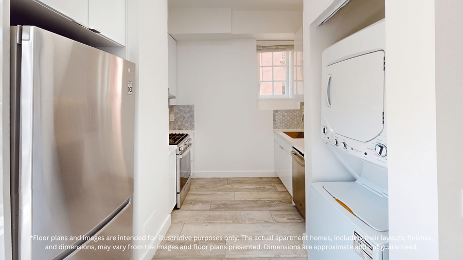 A kitchen with a stainless steel refrigerator and white cabinets.