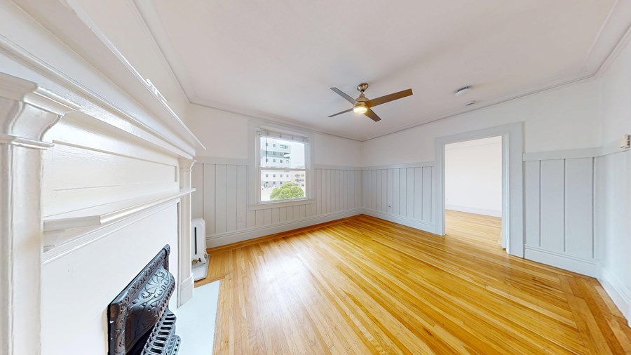 A room with wooden floors and white walls.