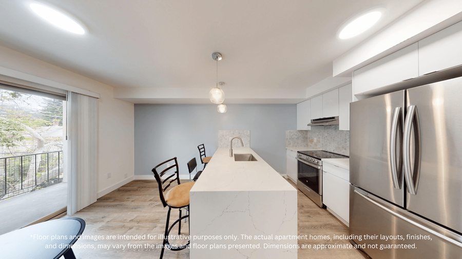 A kitchen with a white countertop and stainless steel appliances.