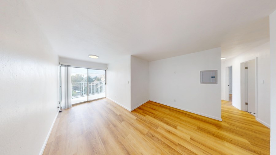 A room with wooden floors and white walls.